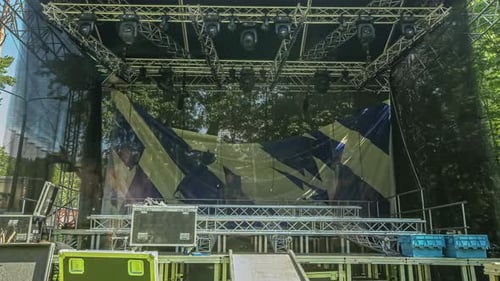 Time lapse of crew setting up the stage for musical event. Concept of lighting setup on stage.