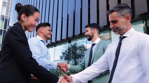 Business People Handshake Outside Office Building