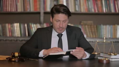 Pensive Male Lawyer Reading Law Book, Preparing for Court