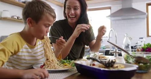 Mother and Child Enjoy Meal Together in Kitchen