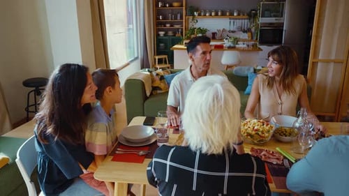 Family Gathered Around Table in Brightly Lit Home