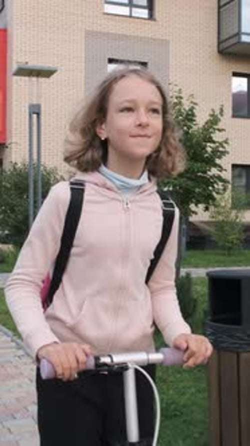 Girl Enjoys Her Scooter Ride to School
