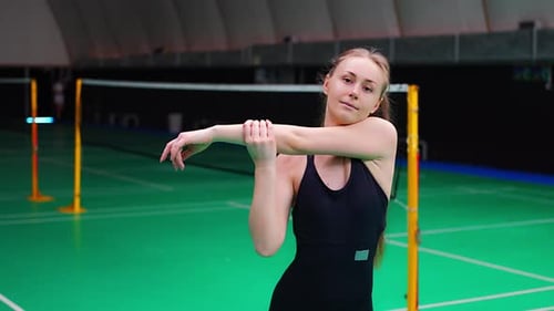 Sports Young Woman with Racket and Shuttlecock is Exercising Doing Warmup Before Playing in