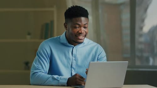 Smiling Man Video Calling with Laptop