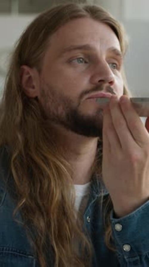Positive Talking Caucasian Man Male Student Guy Recording Voice Mail with Modern Mobile Phone