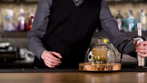 Bartender Smokes Cocktail Under Glass Dome