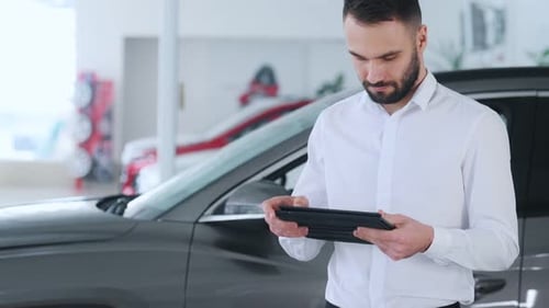 Adult Using Tablet in Car Showroom