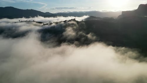 Serene atmosphere with low clouds and hills