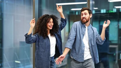 Business Colleagues Dance to Celebrate Success in Modern Office