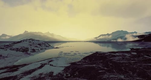 Majestic Twilight Over a Serene Mountain Lake with Reflections of Peaks