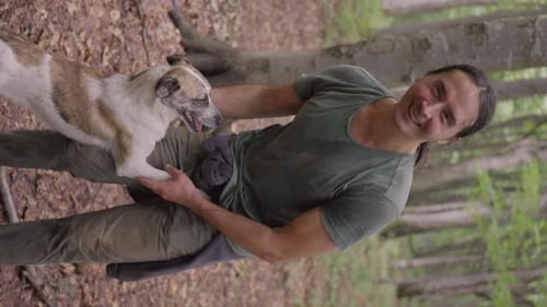 A Man Rests in the Forest a Stray Dog is Glad to See Him