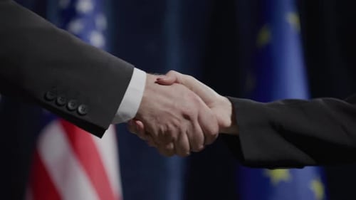 Formal Handshake with US and EU Flags