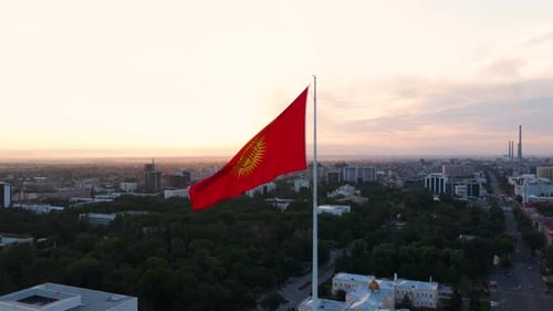 Kyrgyzstan Flag Flies High Above Bishkek at Sunrise