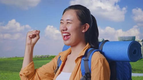 Close Up Side View Of Asian Female Hiker Celebrating in Stonehenge