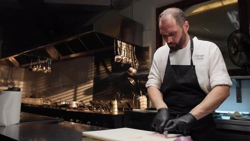 Chef Carefully Cutting an Onion in Commercial Kitchen