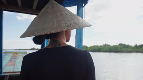 Woman In Conical Hat Seen In Back View