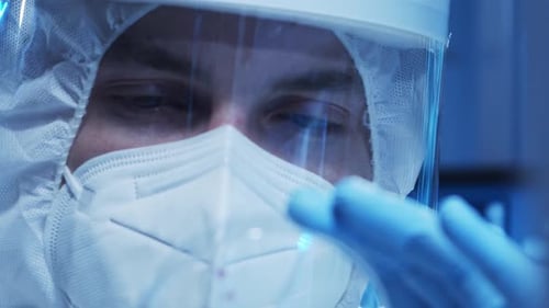 Medical Professional in Protective Suit with Mask and Shield
