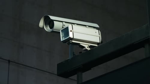 Camera Installed on Wall of the Building Scan the Area for Surveillance Purposes