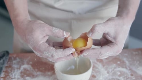 Cracking an Egg into Bowl for Baking