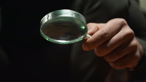 Hand Holding Magnifying Glass Up Close