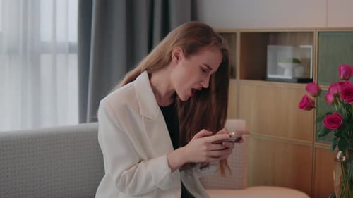 Woman in Blazer Looks at Cellphone