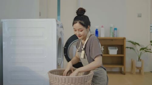 Young Adult Woman Doing Laundry at Home