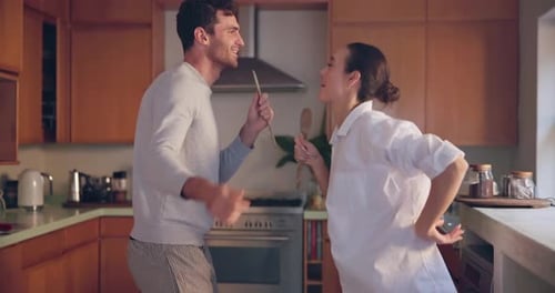 Couple Dances and Sings in Kitchen with Spoons