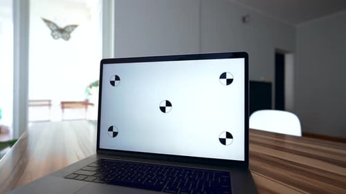 Male Freelancer Works at Laptop with White Chromakey Screen