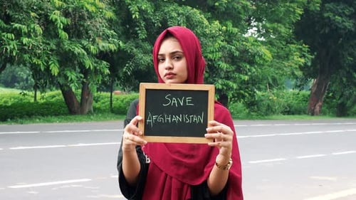 Woman Holding Sign: Save Afghanistan