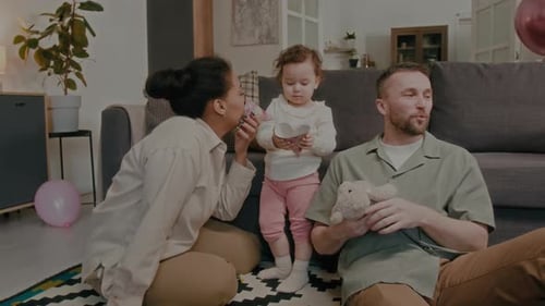 Family Celebrates Toddler's Birthday Party At Home