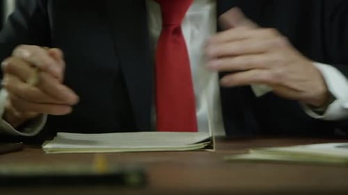 Trump close up - puts down work to take out his phone to tweet HD