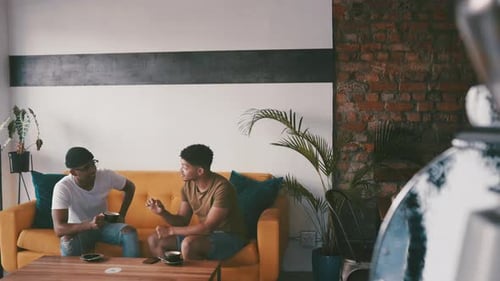 Friends, talking and men on coffee shop sofa for bonding, discussion and chatting together