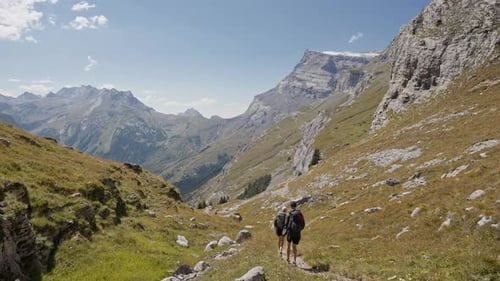 Couple hiking in Alps of Switzerland during daytime