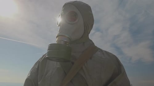 Person in Hazmat Suit and Gas Mask