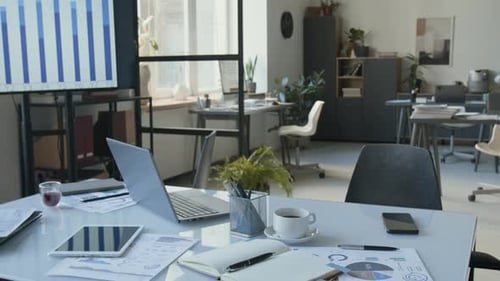 Desk with Laptop, Coffee, Tablet and Stationery in Modern Office