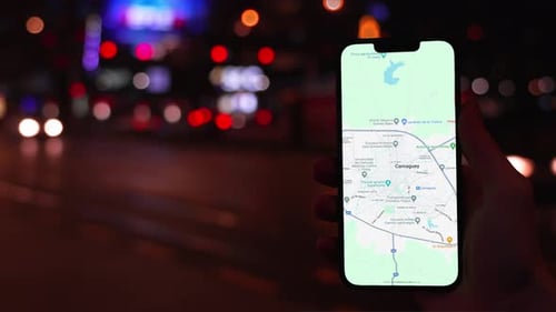 Holding Smart Phone with Map at Night