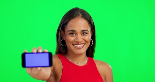 Happy woman, phone and mockup on green screen for advertising against a studio background