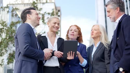 Business People Laughing in a Business Meeting in the Street