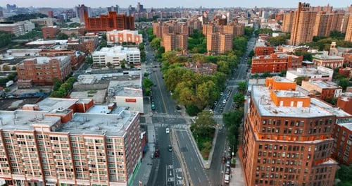 Two highways merge into one. Busy roads around the green residential area.