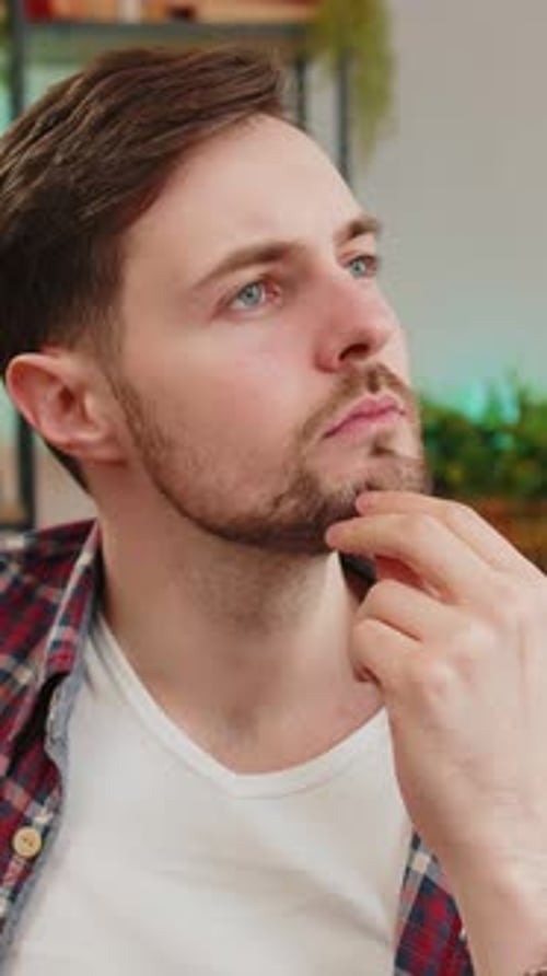 Thoughtful Caucasian Man Sitting at Home Looks Pensive Thinks Over Life Concerns or Unrequited Love