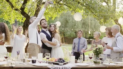 Wedding reception celebration in backyard garden with bride groom and guests