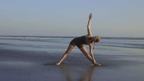 Woman Practicing Yoga on Beach at Daytime