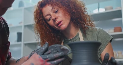 Woman Shaping Clay Vase in Pottery Class