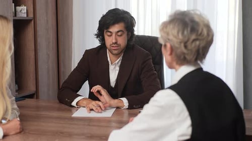 Business Discussion Between Colleagues in Office Setting