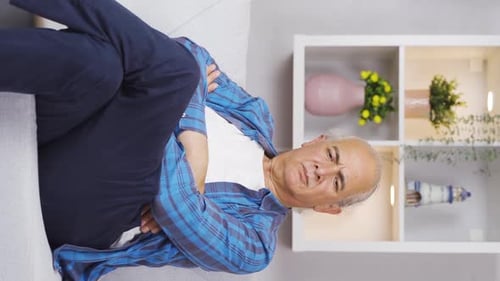Vertical video of The old man who is not feeling well.