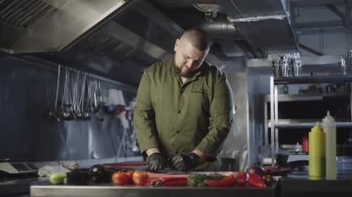 Professional Chef Cuts Vegetables in Commercial Kitchen