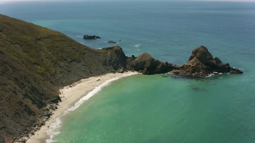 Exploring Hidden Sandy Beaches Nestled Beneath Steep Green Coastal Mountains