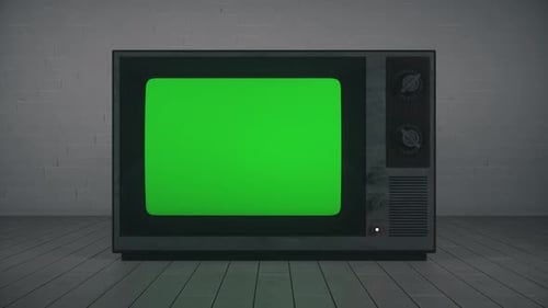 Vintage retro TV green screen in a dark room. Zoom In. You can replace green screen with the footage