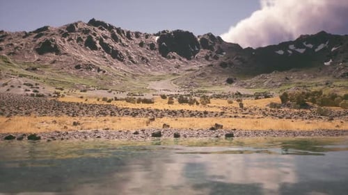 Scenic Mountain Landscape with Clear Water Reflecting the Sky During Daytime
