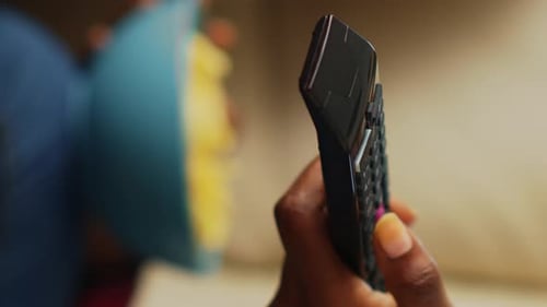 Vertical Video Woman Switching Channels with Tv Remote Control